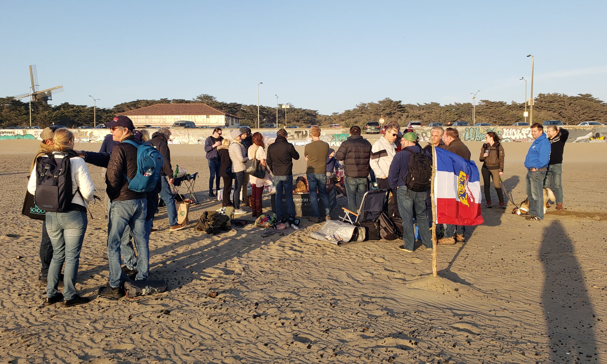 People starting bonfire on the beach to celebrate spring